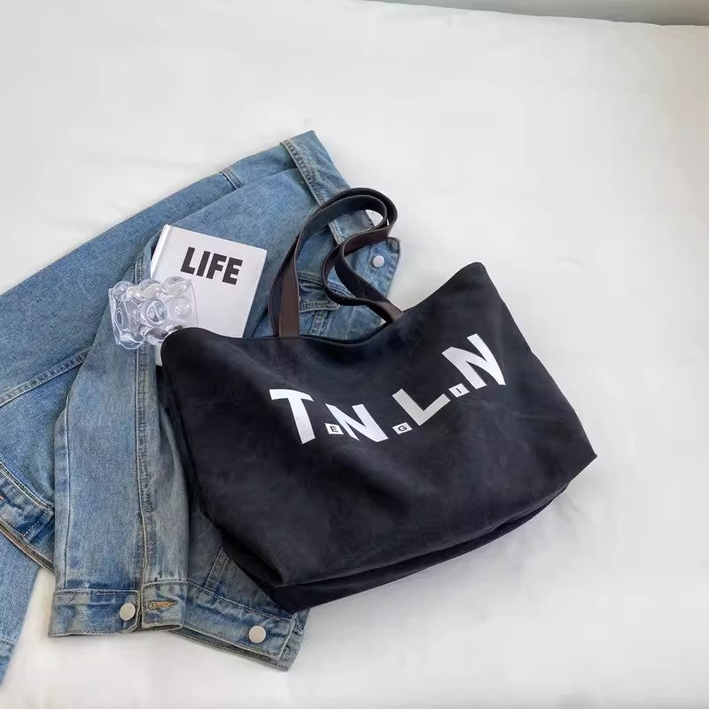 Large-capacity canvas shoulder tote bag.