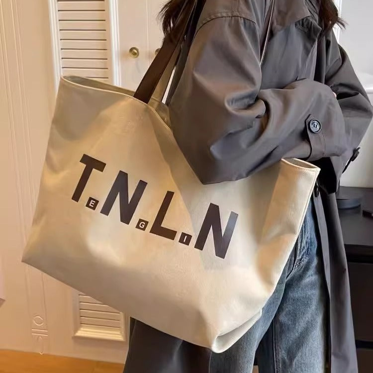 Large-capacity canvas shoulder tote bag.