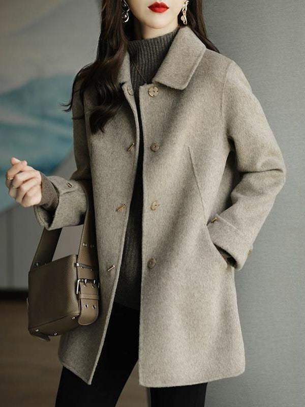 A woman wearing a woolen coat