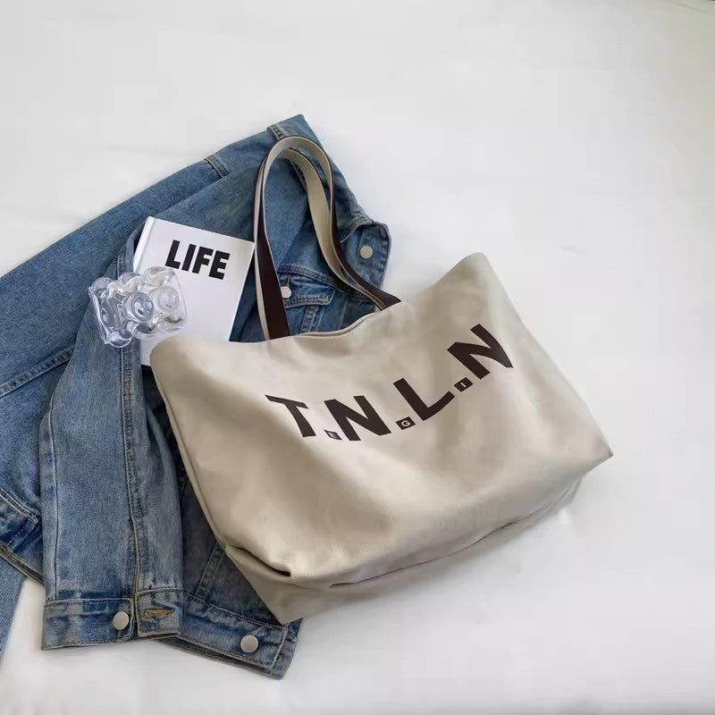 Large-capacity canvas shoulder tote bag.