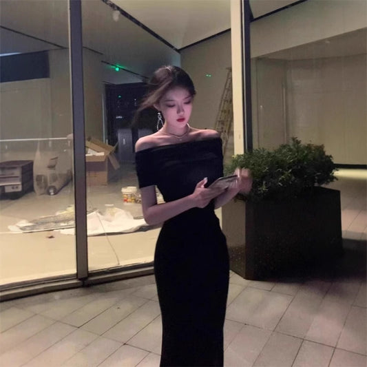 A woman in a one-shoulder dress