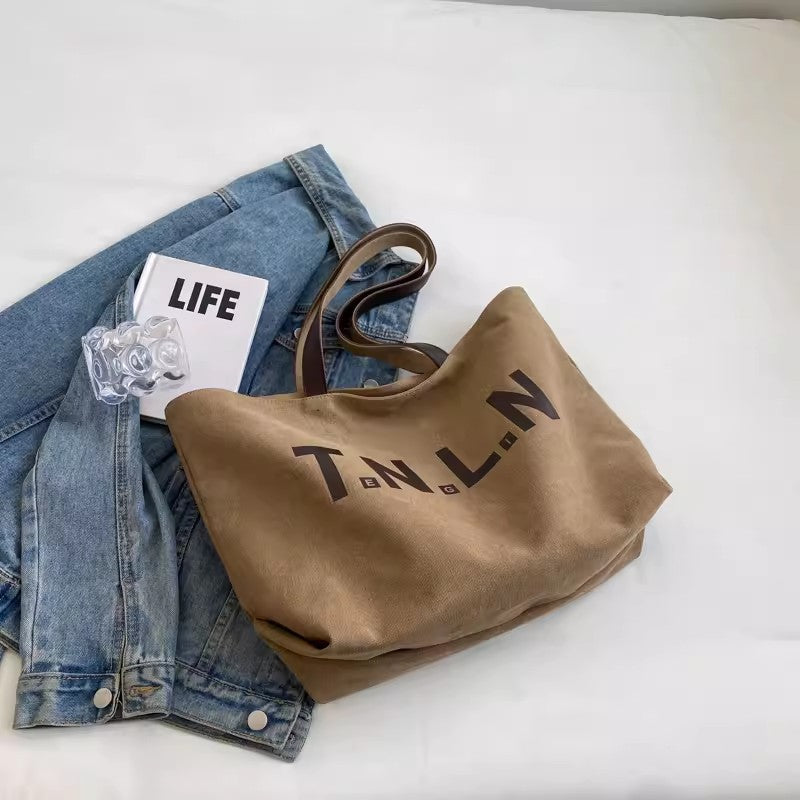 Large-capacity canvas shoulder tote bag.