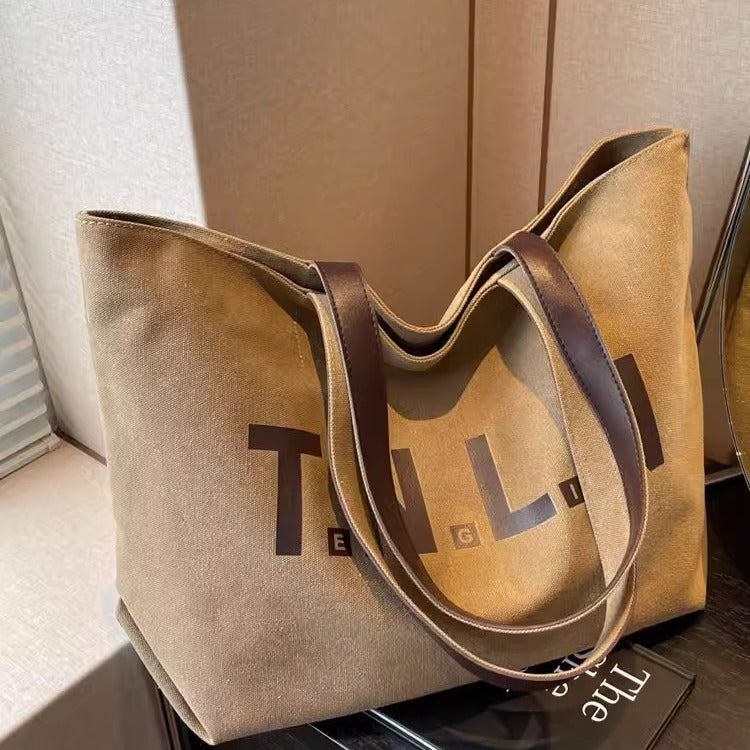 Large-capacity canvas shoulder tote bag.